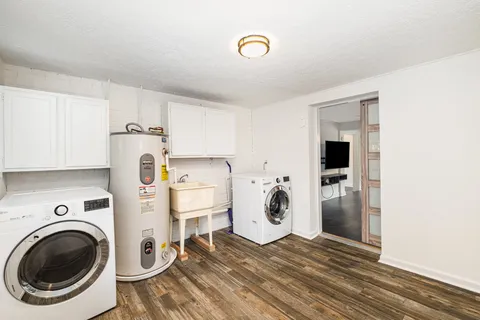a view of a kitchen with a sink washer and dryer