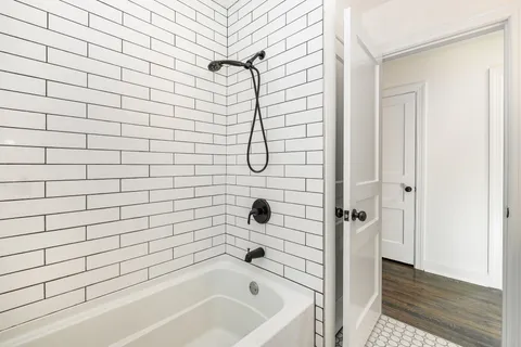 a bathroom with a bathtub and shower