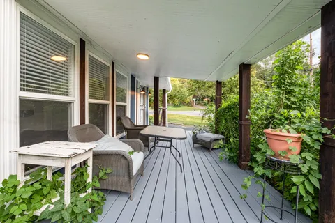 a view of a patio with table and chairs and potted plants