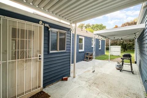 a view of a porch with furniture and a gate