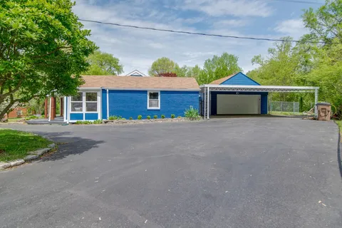 a view of yellow house with a large window