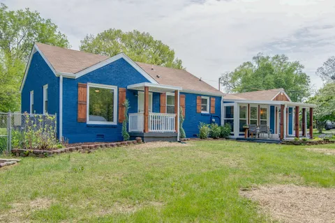 a view of a house with porch and furniture