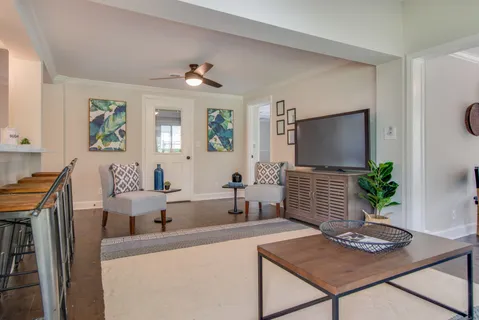 a living room with furniture and a flat screen tv