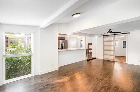 a view of a kitchen with wooden floor and a kitchen