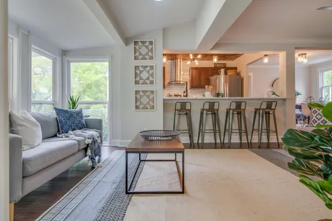 a living room with furniture a window and plants