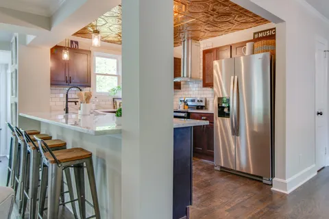 a kitchen with kitchen island a counter top space and stainless steel appliances