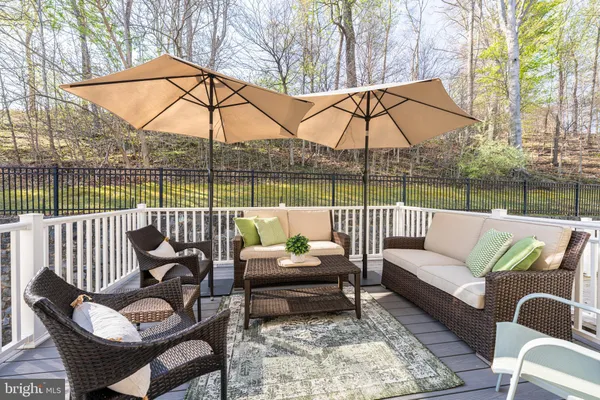 a view of a patio with couches chairs and a umbrella