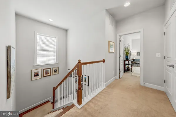 a view of a hallway with windows and stairs