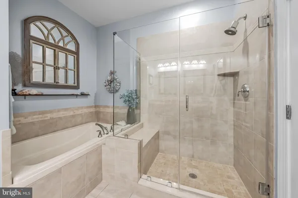 a bathroom with a bathtub and a shower