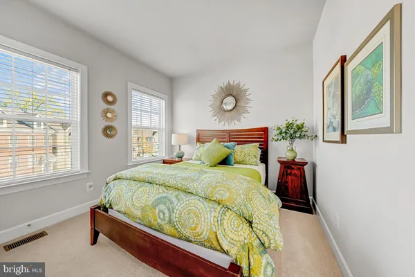 a bed sitting in a bedroom next to a window