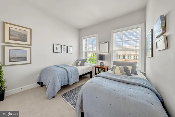 a bedroom with two beds and a window