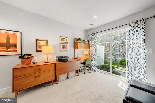 a bedroom with furniture and a large window