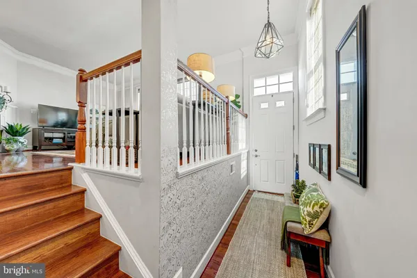 a view of entryway and hall with wooden floor