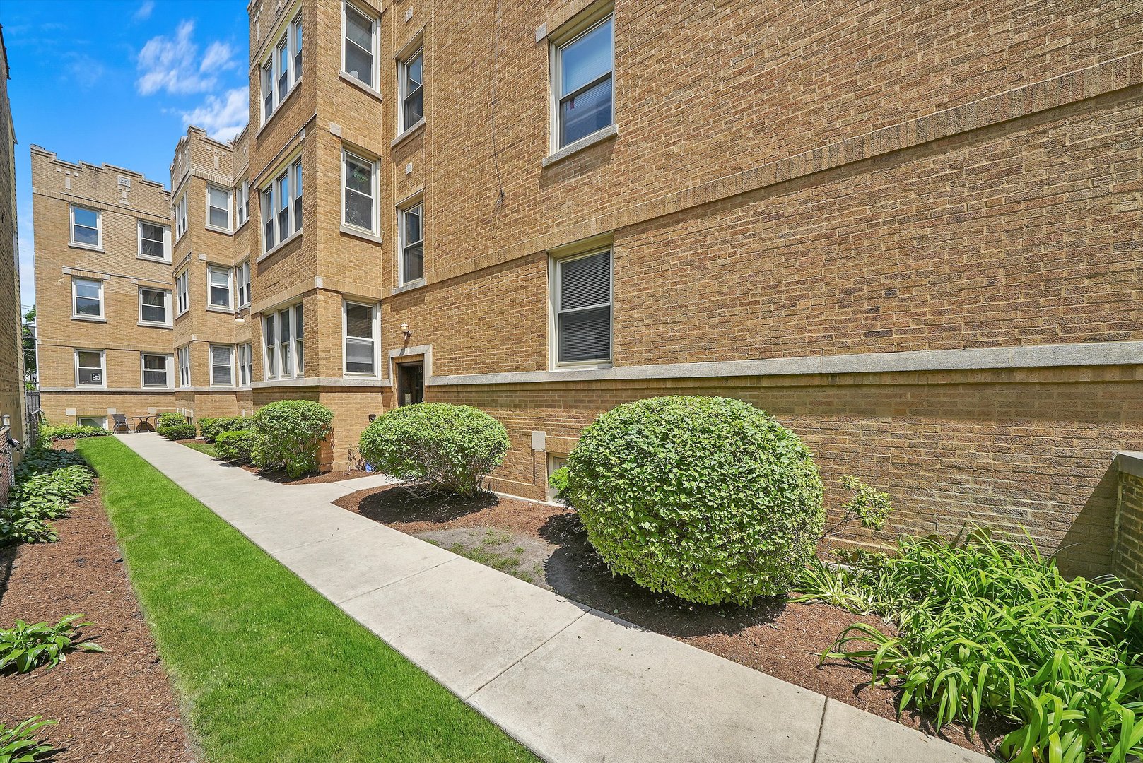 1928 West Addison Street, Unit 1S Chicago, IL 60613 - Photo 2 of 25 a front view of a house with a garden