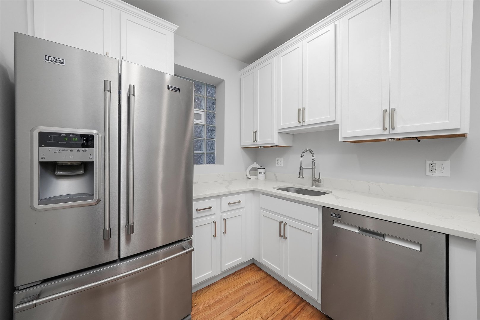1928 West Addison Street, Unit 1S Chicago, IL 60613 - Photo 4 of 25 a kitchen with stainless steel appliances granite countertop a refrigerator sink and cabinets