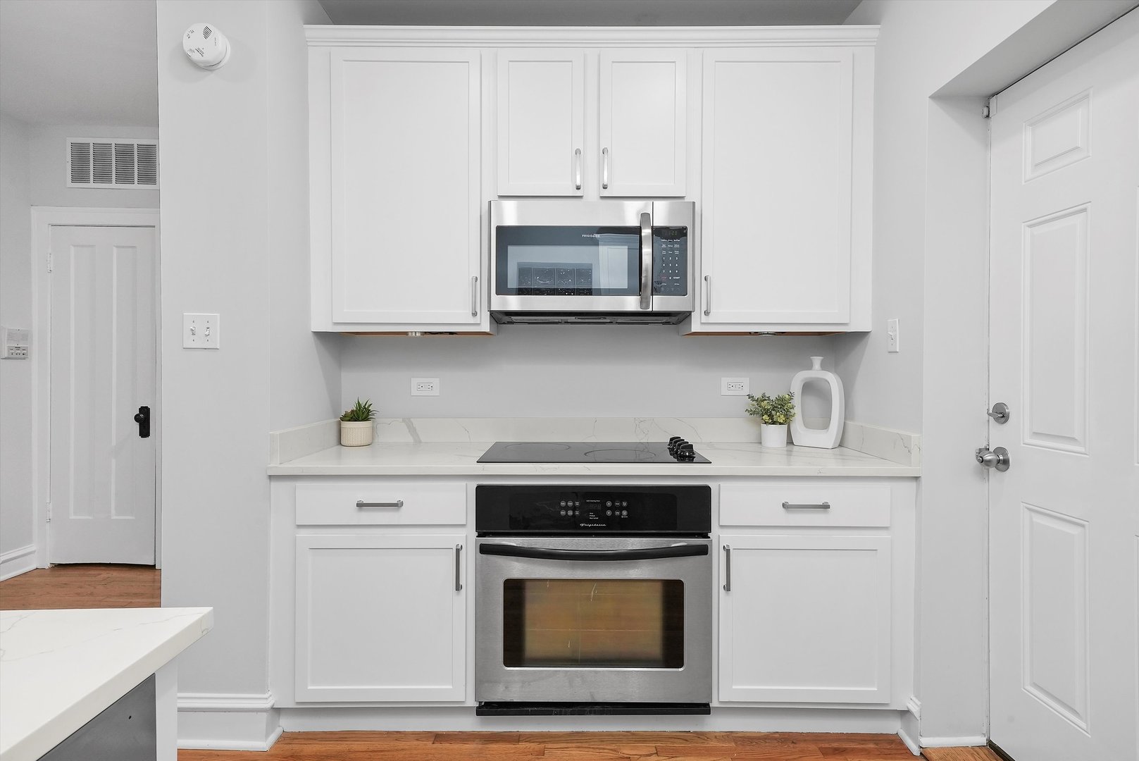 1928 West Addison Street, Unit 1S Chicago, IL 60613 - Photo 6 of 25 a kitchen with stainless steel appliances granite countertop a stove and a white cabinet
