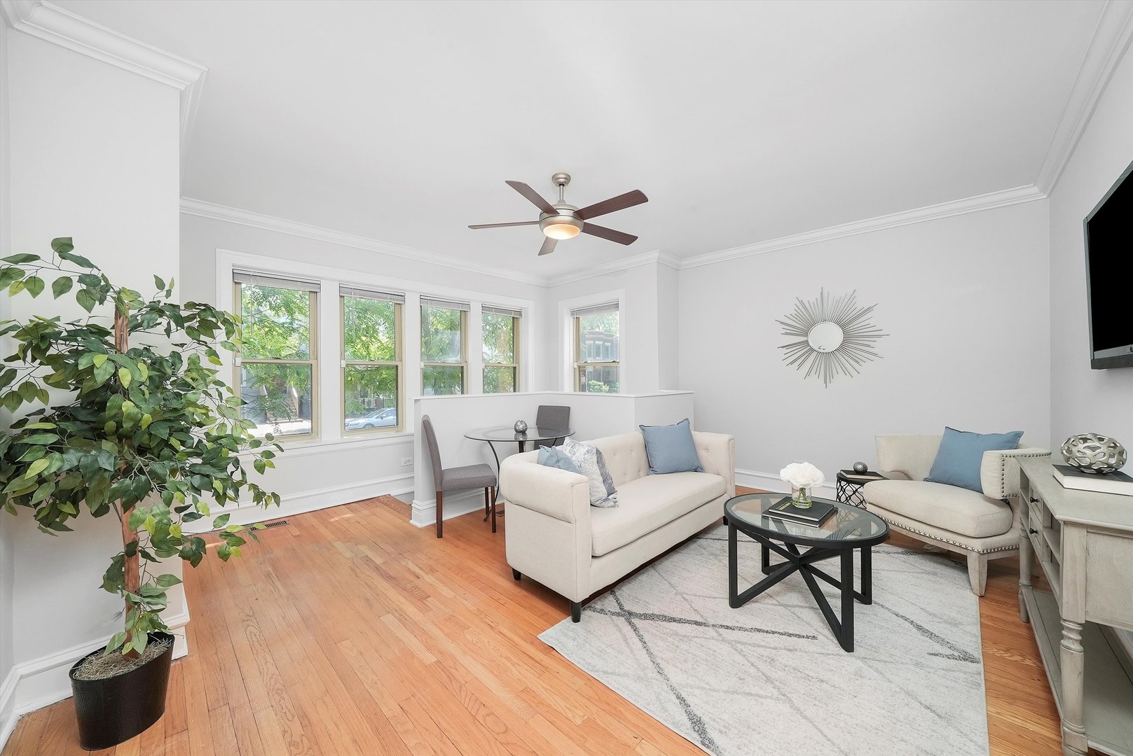 1928 West Addison Street, Unit 1S Chicago, IL 60613 - Photo 7 of 25 a living room with furniture and a large window with garden view