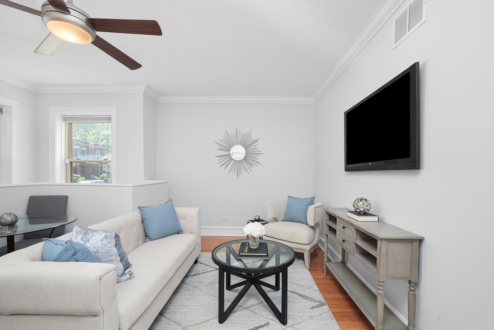 1928 West Addison Street, Unit 1S Chicago, IL 60613 - Photo 8 of 25 a living room with furniture and a flat screen tv