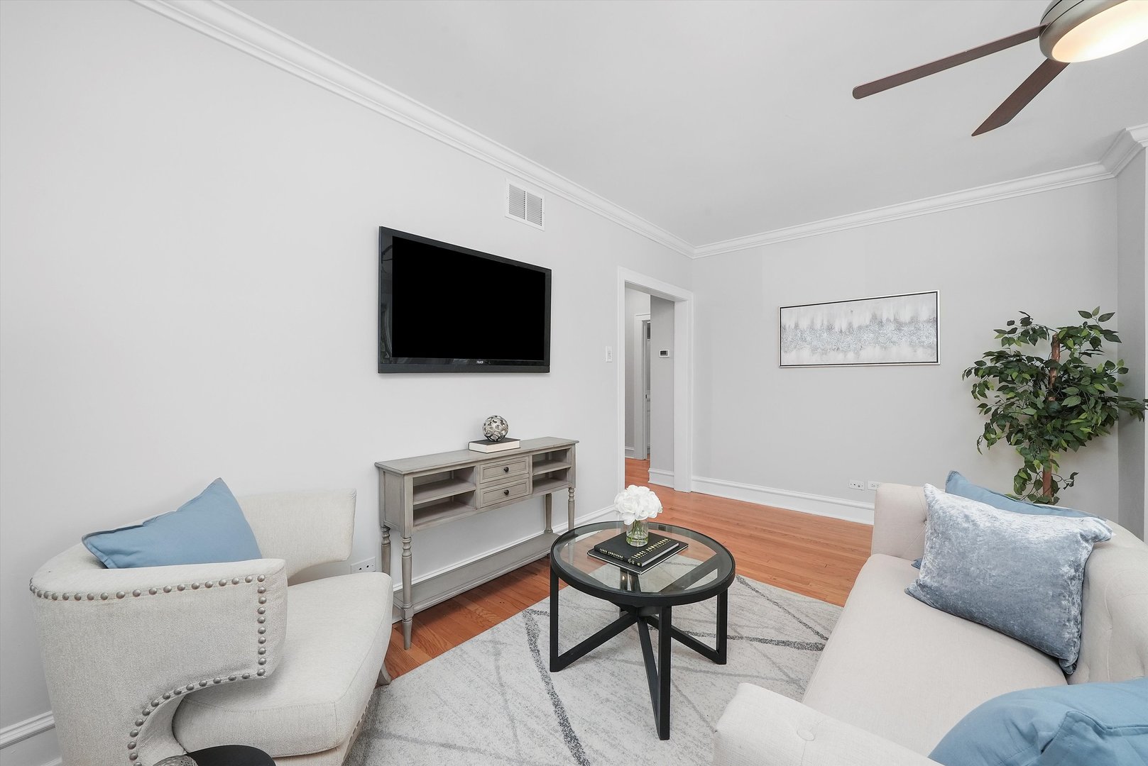 1928 West Addison Street, Unit 1S Chicago, IL 60613 - Photo 9 of 25 a living room with furniture and a flat screen tv