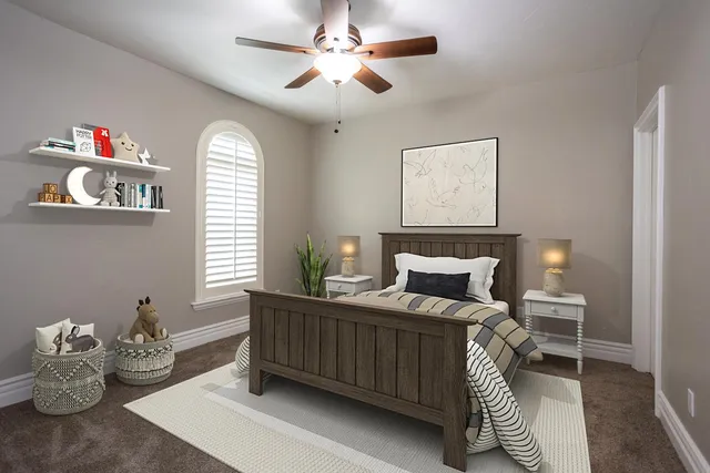 a bedroom with a bed and a chandelier