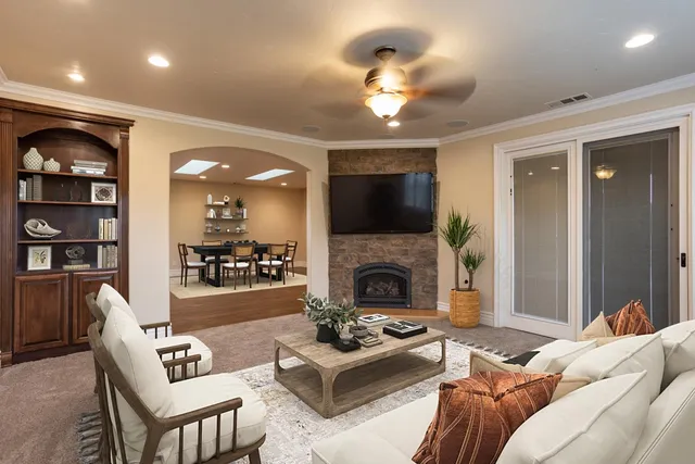 a living room with furniture and a fireplace