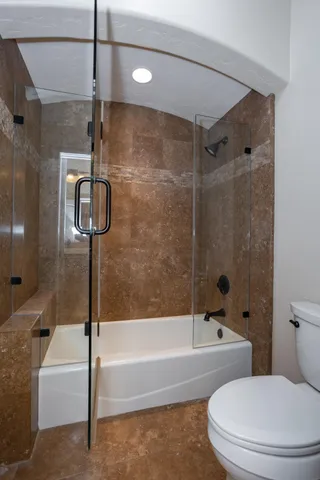 a bathroom with a toilet and a bathtub