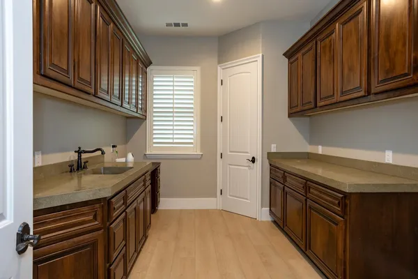 a kitchen with stainless steel appliances granite countertop a sink stove and cabinets