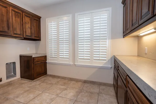 a kitchen with granite countertop a sink and a stove top oven