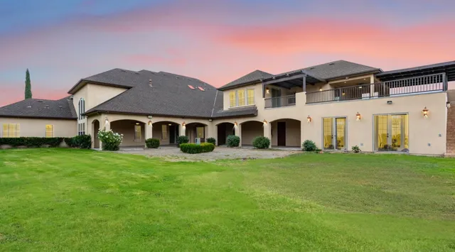 a front view of a house with a garden