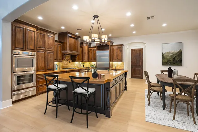 a large kitchen with a table and chairs