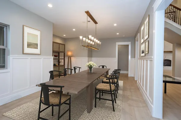 a view of a dining room with furniture and chandelier