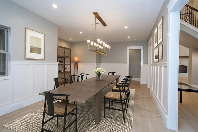 a view of a dining room with furniture and chandelier