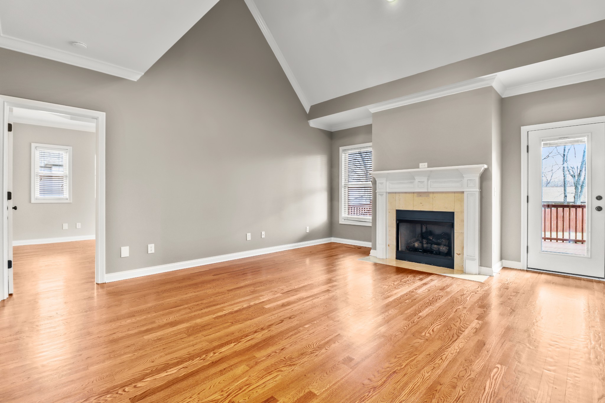 331 Tivoli Trail Springfield, TN 37172 - Photo 14 of 44 a view of an empty room with wooden floor fireplace and a window