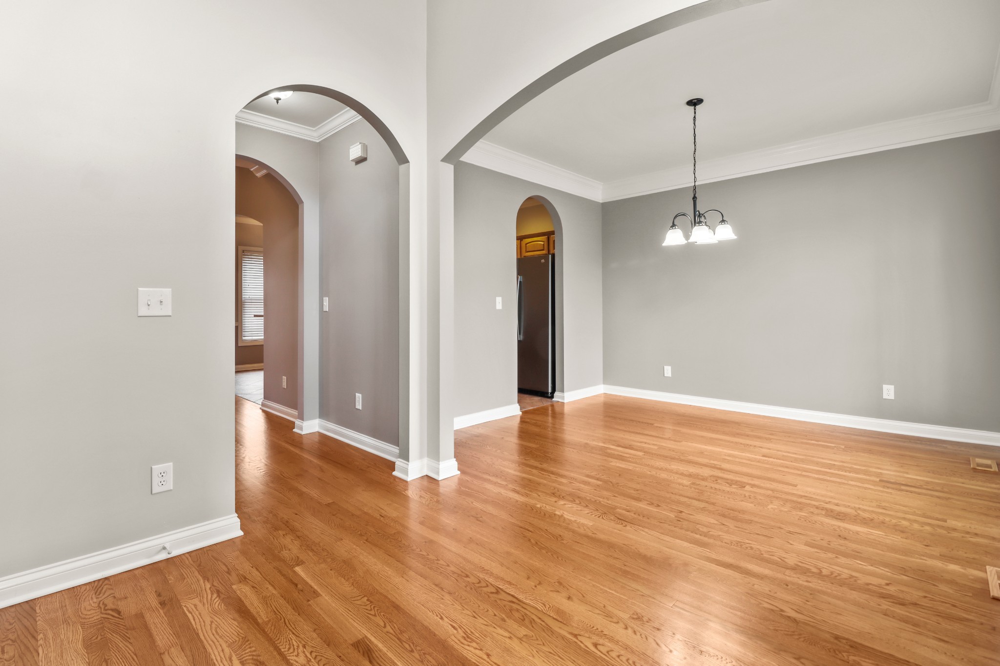 331 Tivoli Trail Springfield, TN 37172 - Photo 10 of 44 an empty room with wooden floor chandelier and glass door