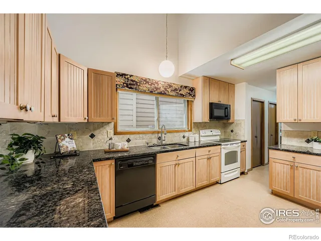 a bathroom with a sink a toilet a mirror and shower