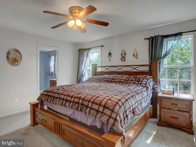 a bathroom with a sink mirror vanity and toilet