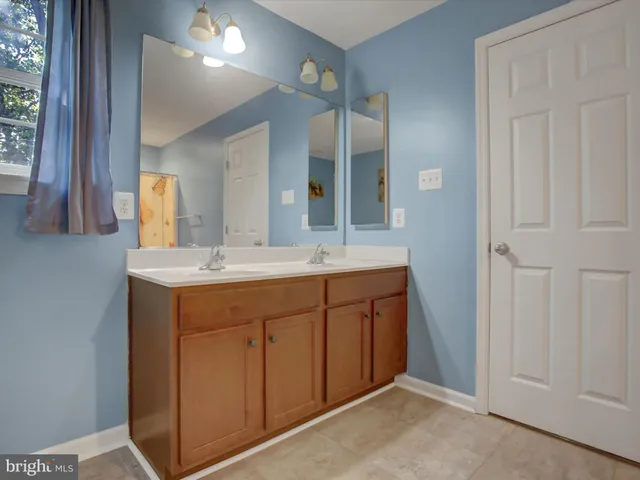 a bathroom with a glass shower door and a sink