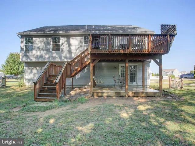 a view of a porch with table and chairs