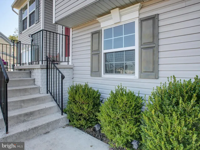 a view of a house with more windows and flower plants
