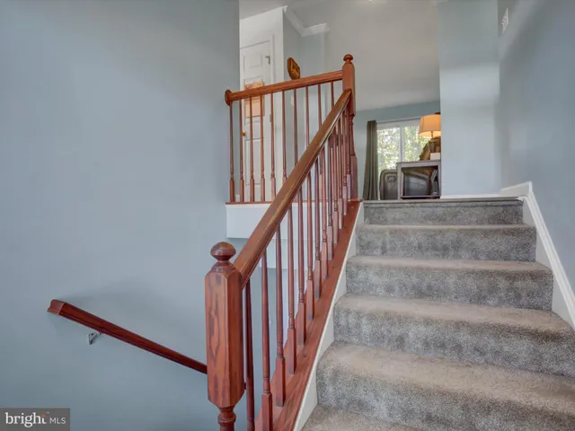 a view of staircase with white walls and window