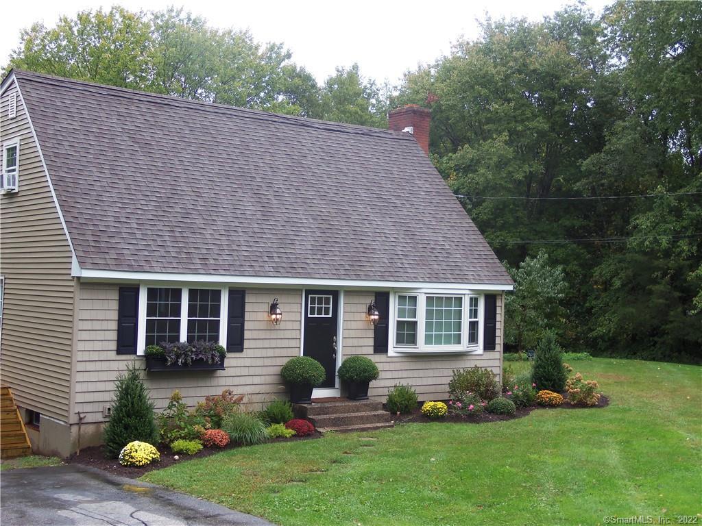 a aerial view of a house with a yard chairs and table