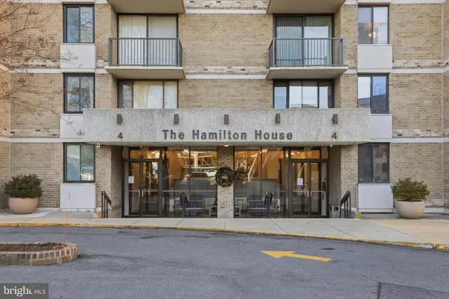 a front view of a building with glass windows and door
