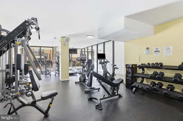 a bedroom with a bed and painting on the wall
