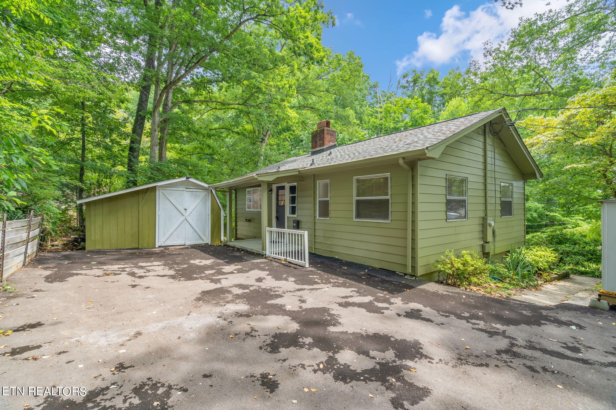 408 Delaware Avenue Oak Ridge, TN 37830 - Photo 2 of 35 a view of a house with a small yard plants and large tree