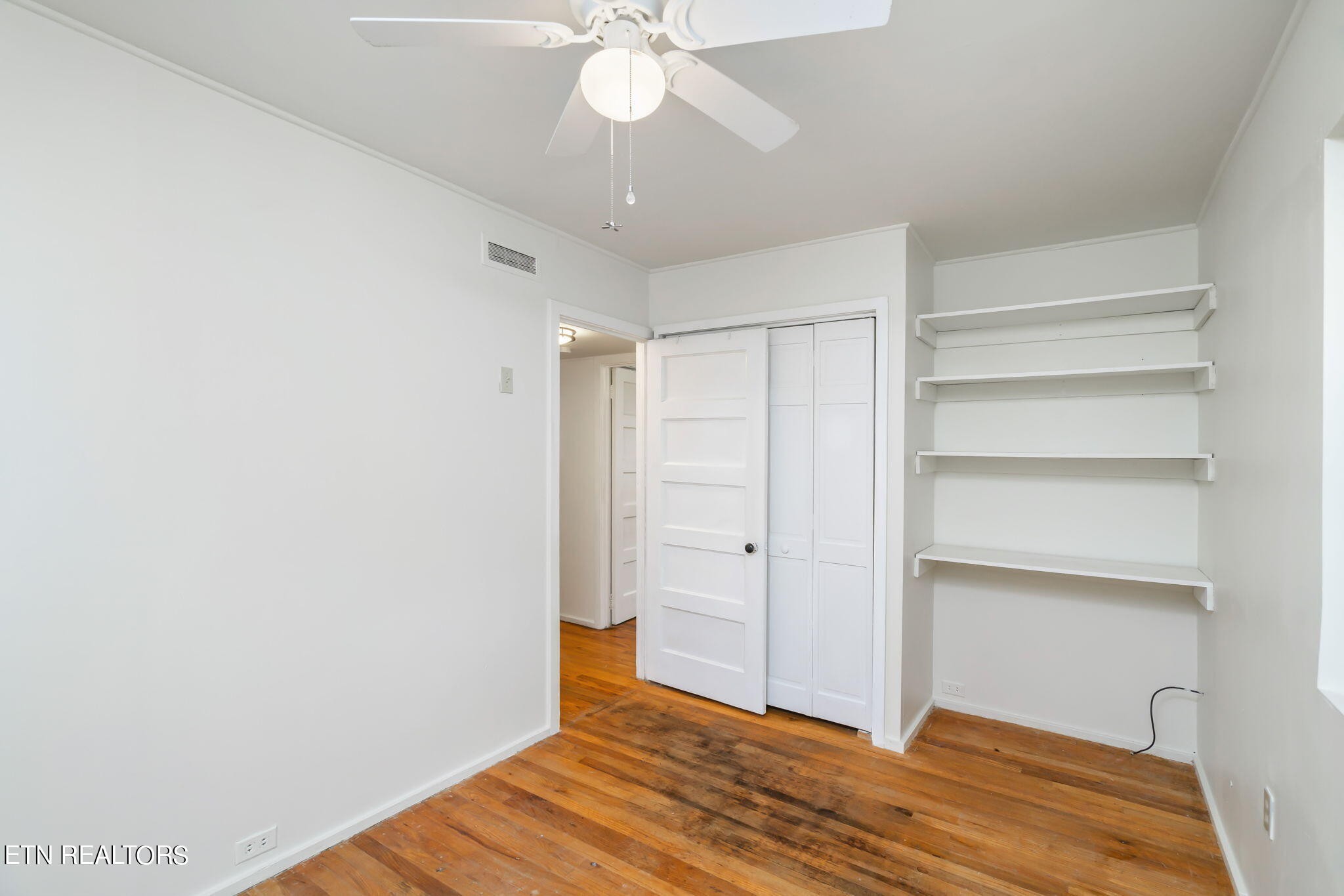 408 Delaware Avenue Oak Ridge, TN 37830 - Photo 23 of 35 a view of empty room with wooden floor and fan