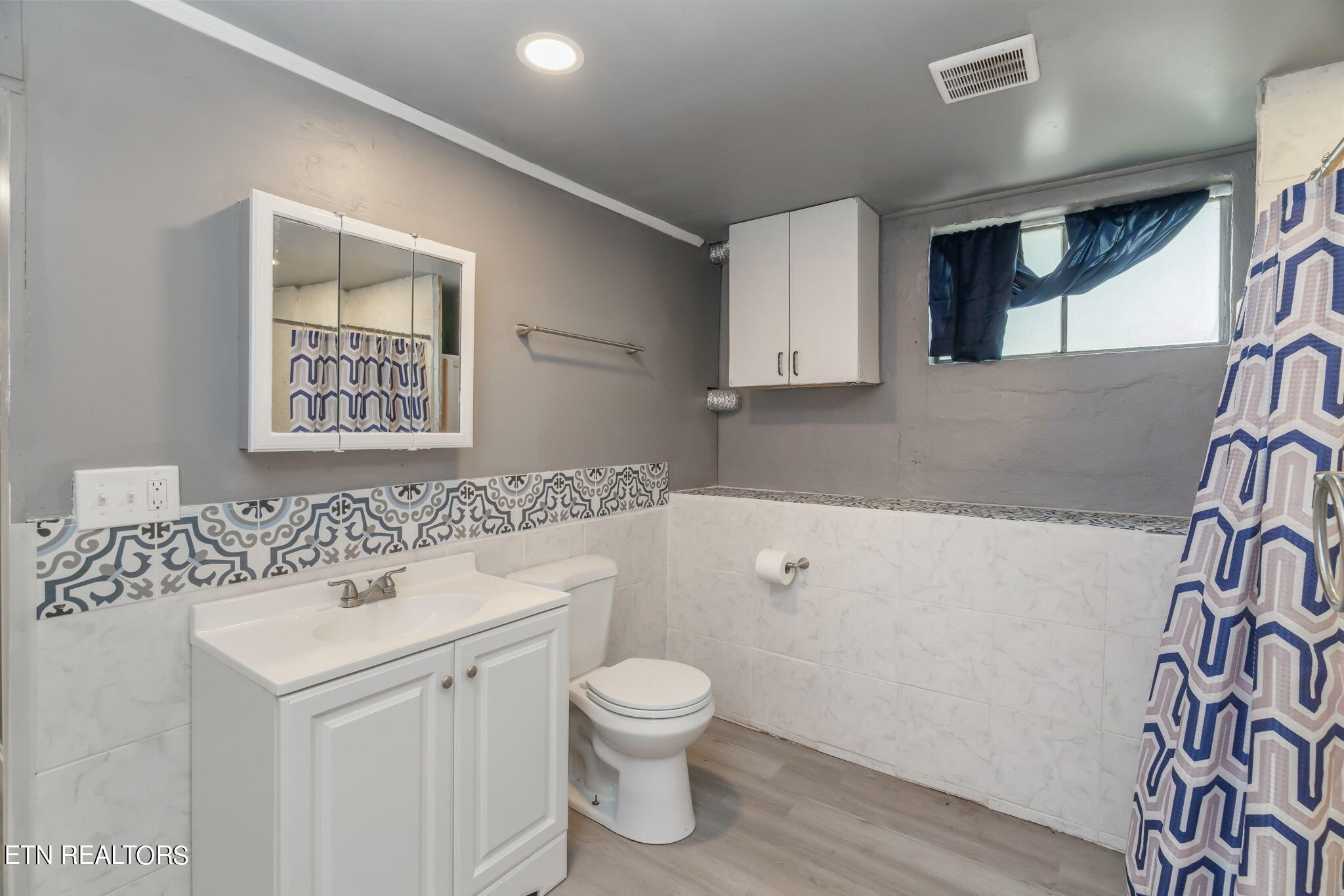 408 Delaware Avenue Oak Ridge, TN 37830 - Photo 27 of 35 a bathroom with a sink a toilet and a large mirror
