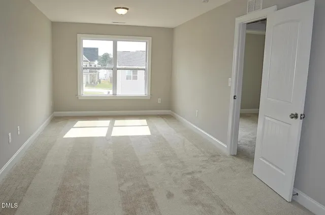 wooden floor fireplace and windows in an empty room