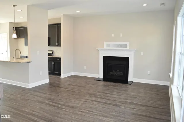 a kitchen with stainless steel appliances granite countertop a sink a stove and microwave
