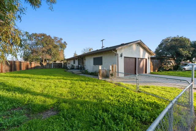 a view of a house with pool and a yard
