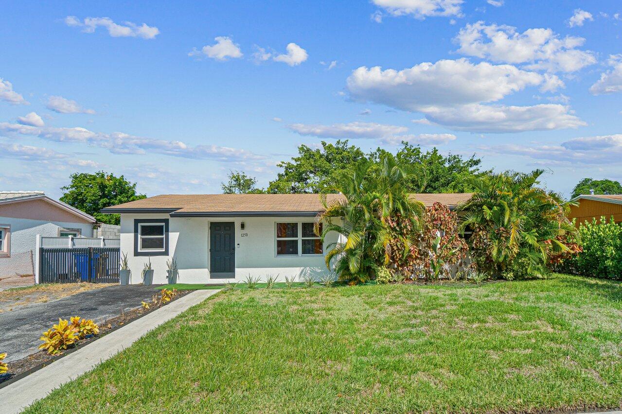 1250 Southwest 6th Avenue Deerfield Beach, FL 33441 - Photo 1 of 22 a front view of house with yard and green space